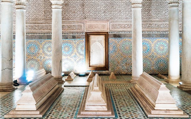 Saadian Tombs interior with ornate tilework and marble columns in Marrakesh.
