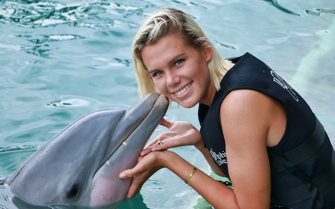 Person interacting with a dolphin at Cozumel's Chankanaab Park.
