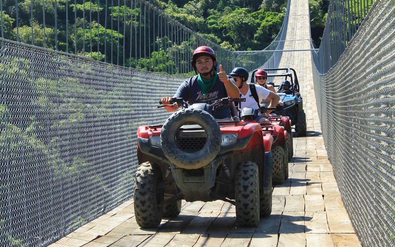 ATVs crossing Jorullo Suspended Bridge in Mexico.