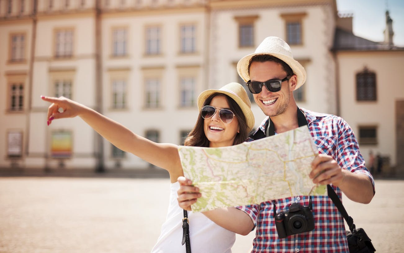 Tourists exploring Puerto Vallarta with a map, enjoying a city tour.