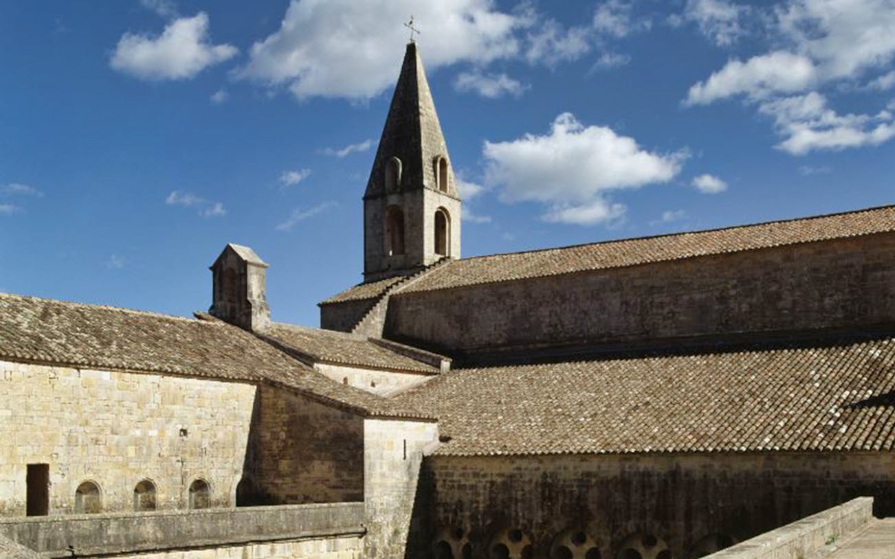 Abbaye du Thoronet stone architecture under blue sky, France.