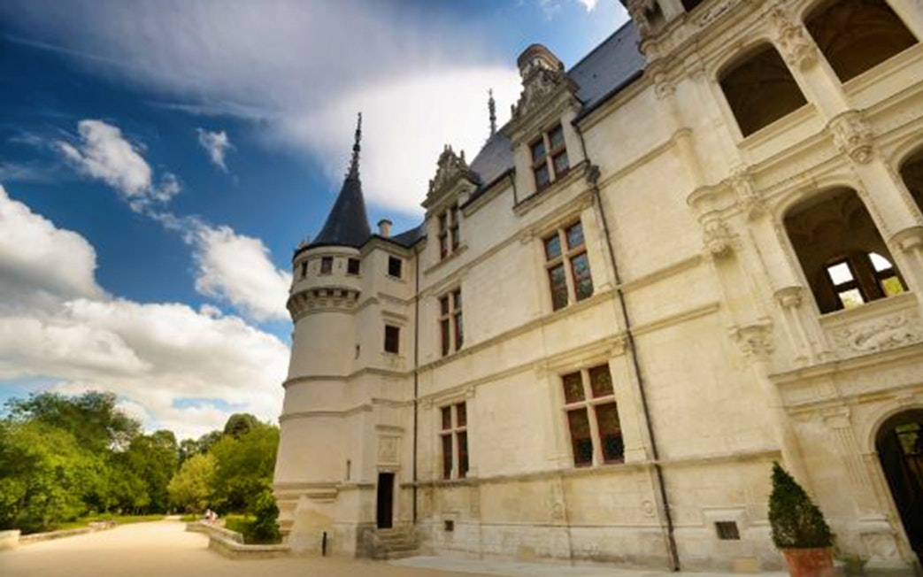 Château Azay-le-Rideau facade with turret under a blue sky, Loire Valley, France.
