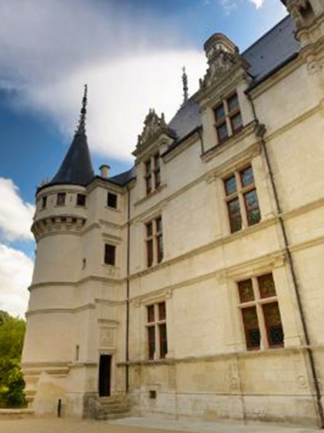 Château Azay-le-Rideau facade with turret under a blue sky, Loire Valley, France.