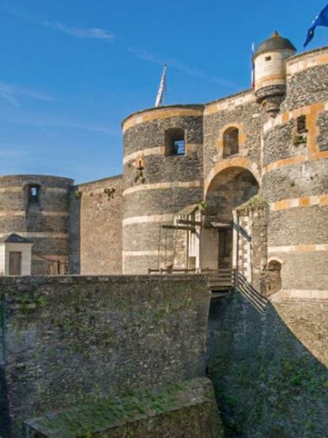 Angers Castle stone towers and entrance bridge in France.