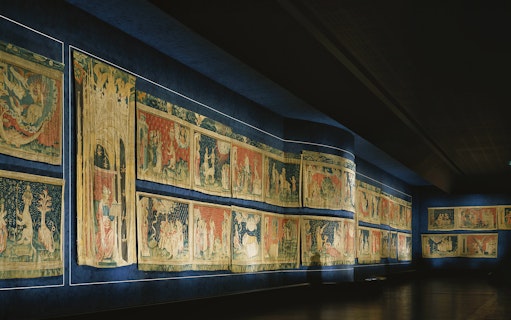 Tapestries displayed inside Angers Castle, depicting historical scenes.