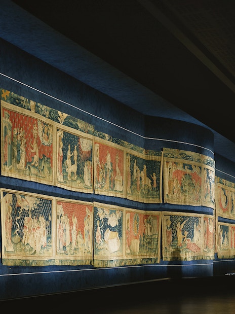 Tapestries displayed inside Angers Castle, depicting historical scenes.