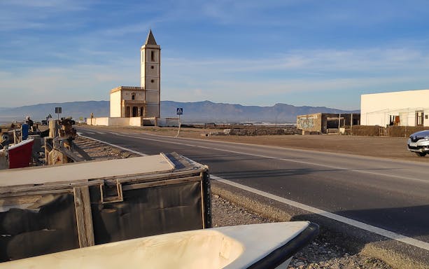 Church of Las Salinas along the road in Cabo de Gata, Almería, with mountains in the background.