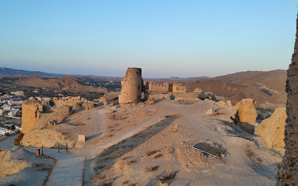 Ruins in Tabernas Desert with distant mountains, seen on a day trip from Almería.