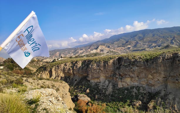 Tabernas Desert landscape with Almería flag, part of Western Movie Locations Walking Tour.