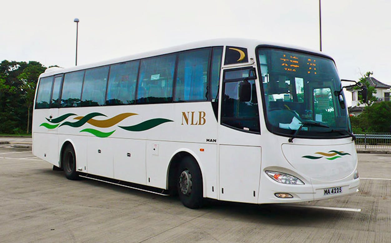 Tour bus for 360 Sky Land Sea Day Pass round trip parked at station.