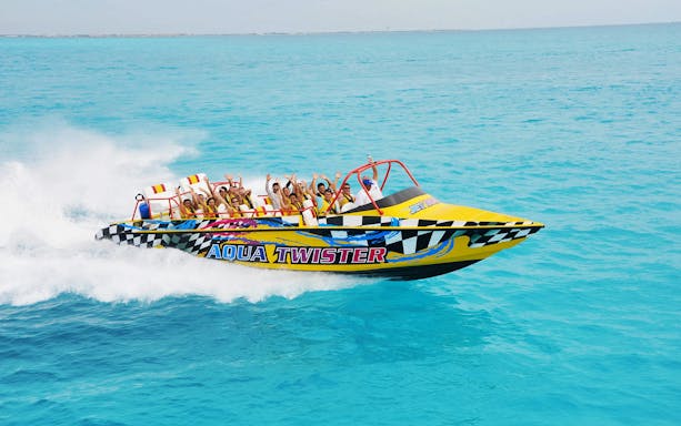 Jet boat with passengers enjoying a ride on turquoise waters in Cancun.