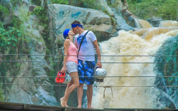 Couple on a bridge at a waterfall during Banderas Bay Sea Safari & Horseback Riding Tour.