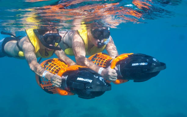 Snorkelers using sea scooters underwater on a luxury yacht tour from Puerto Vallarta.