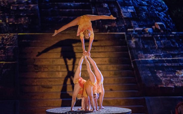 Acrobats performing a handstand pyramid during Rhythms of the Night: VIP Dinner Show.