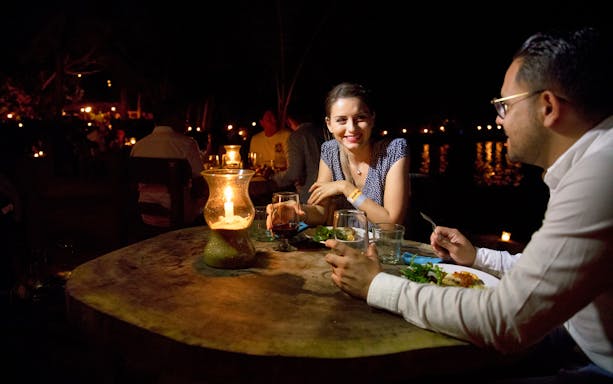 Couple enjoying candlelit dinner at Rhythms of the Night VIP show, Puerto Vallarta.