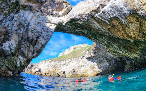 Snorkelers exploring rocky archway at Islas Marietas, Puerto Vallarta eco-tour.