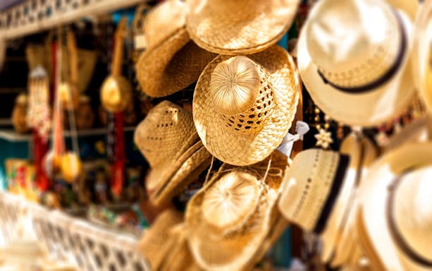 Straw hats displayed at a market stall in San Sebastian during a day trip from Puerto Vallarta.