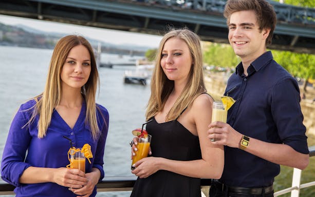 Guests enjoying drinks on a Danube River cruise in Budapest.