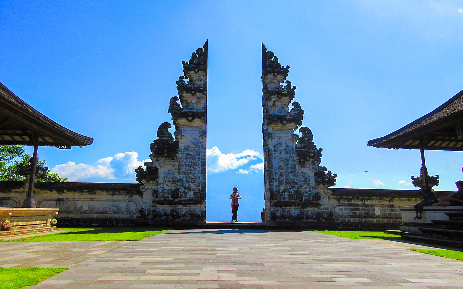 Lempuyang Temple gates with person at sunrise, Bali.