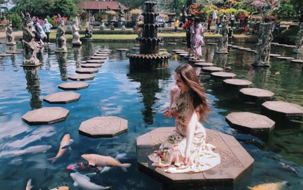 Stepping stones and koi pond at Tirta Gangga Water Palace, Bali.
