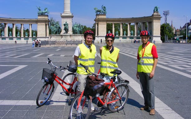 Cyclists at Heroes' Square during Budapest small group city bike tour.