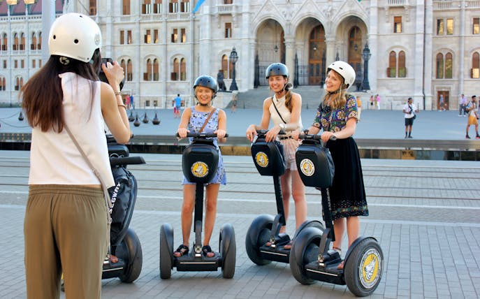 Tourists on Segways in front of the Hungarian Parliament Building, Budapest.