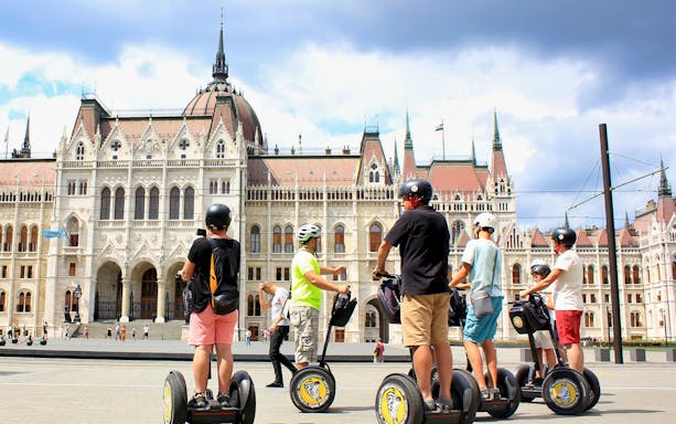 Tourists on Segways in front of the Hungarian Parliament Building, Budapest.