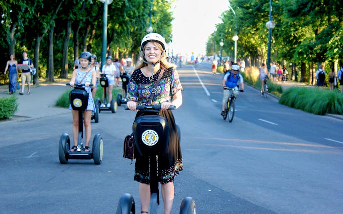 Tourists riding Segways through Budapest City Park on a guided tour.
