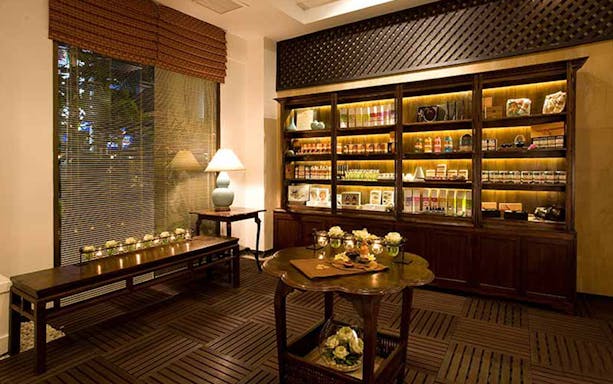 Let's Relax Thai Massage reception area with wooden decor and product display.