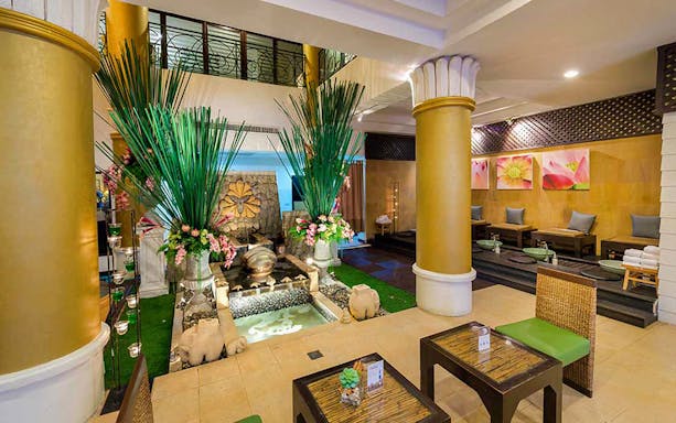 Luxurious interior of Let's Relax Thai Massage with decorative plants and seating area.