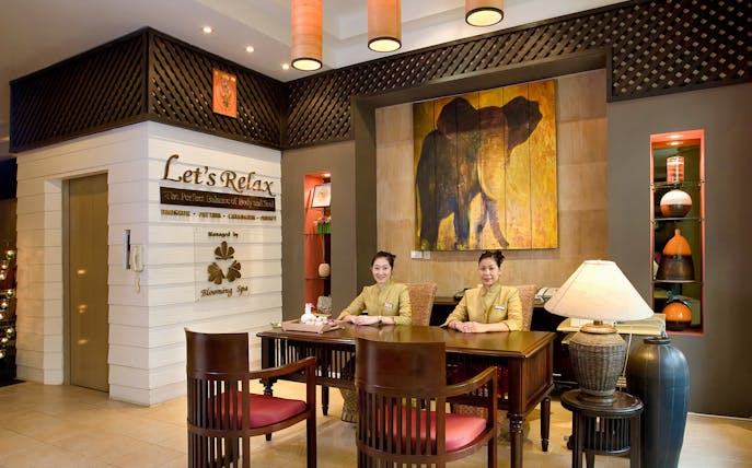 Reception area of Let's Relax Thai Massage with staff at the desk.