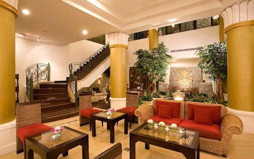 Elegant spa lobby with seating area, plants, and decorative elements at Let's Relax Four Hands Thai Massage.
