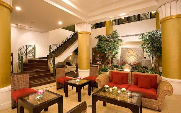 Elegant spa lobby with seating area, plants, and decorative elements at Let's Relax Four Hands Thai Massage.