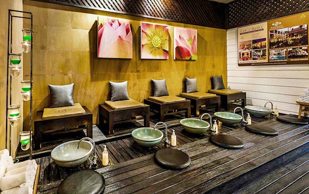 Spa seating area with foot basins at Let's Relax Four Hands Thai Massage.