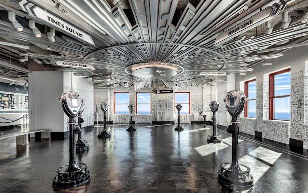 Observation deck with viewfinders and NYC landmarks at the Empire State Building.