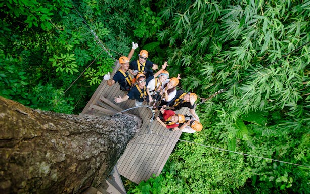 Group preparing for zipline adventure in Phuket jungle canopy.