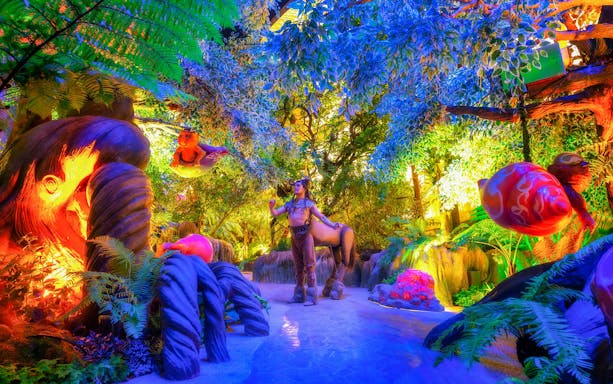 Centaur in vibrant forest at Tribhum: The Mystical Three Worlds Adventure Park.