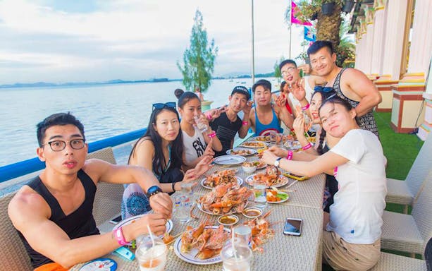 Group dining by the sea at Sukhawadee House, Pattaya.