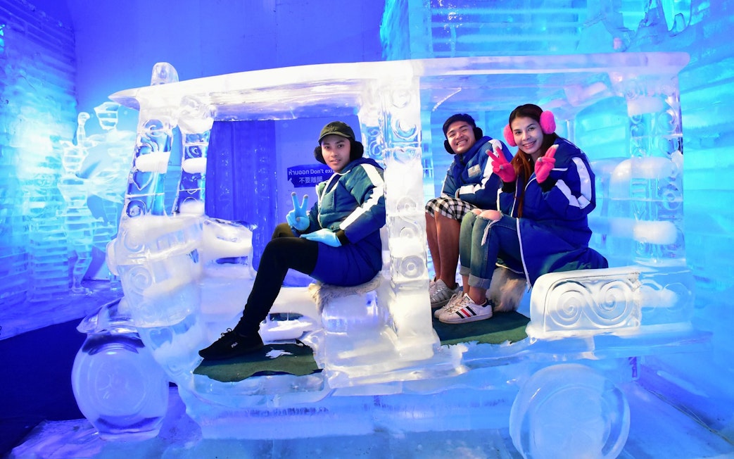 Visitors sitting in an ice tuk-tuk at Frost Magical Ice of Siam, Pattaya.