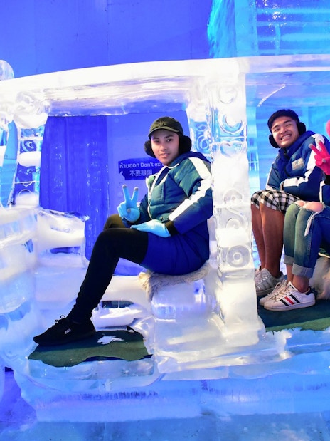 Visitors sitting in an ice tuk-tuk at Frost Magical Ice of Siam, Pattaya.