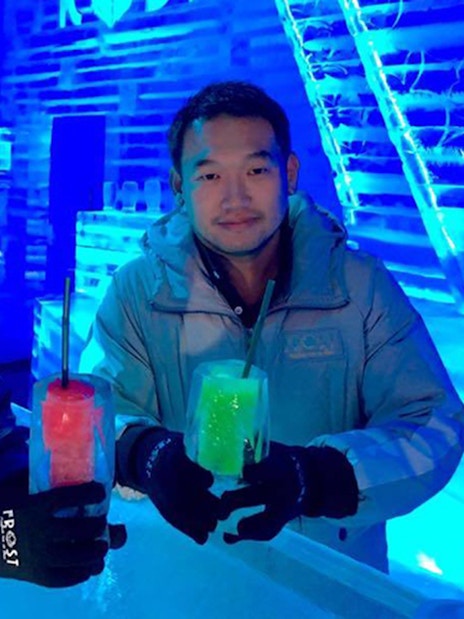 Visitors enjoying drinks at Frost Magical Ice of Siam, surrounded by ice sculptures.