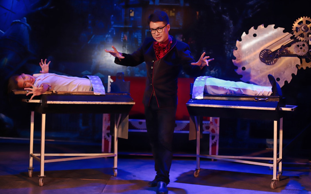 Magician performing illusion with assistant at Tuxedo Illusion Hall, Pattaya.