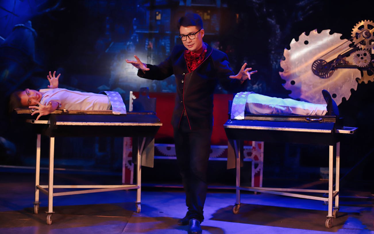 Magician performing illusion with assistant at Tuxedo Illusion Hall, Pattaya.