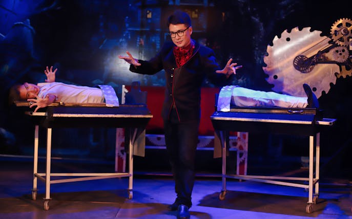 Magician performing illusion with assistant at Tuxedo Illusion Hall, Pattaya.