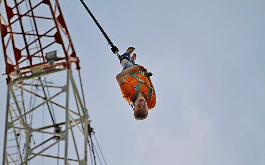 Person bungy jumping from a tower in Pattaya, Thailand.