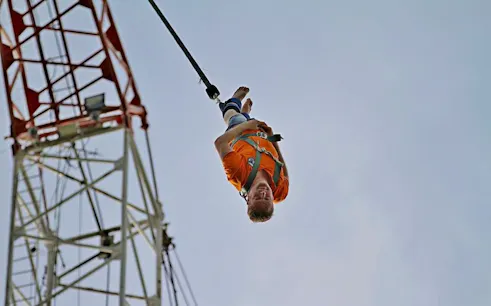 Person bungy jumping from a tower in Pattaya, Thailand.
