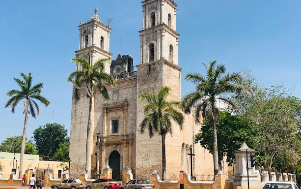Valladolid's San Servacio Church with palm trees, part of Chichén Itzá Basic, Hubiku Cenote & Valladolid Tour.