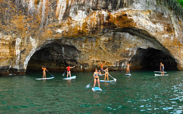 Paddleboarders explore caves at The Arches near Puerto Vallarta.