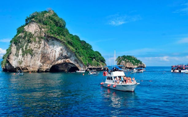Boat near The Arches rock formations in Animas and Quimixto, Puerto Vallarta.