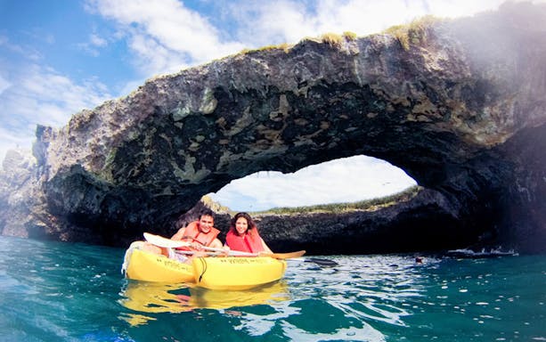 Catamaran sailing near Marietas Island, Mexico, with tourists enjoying the ocean view.